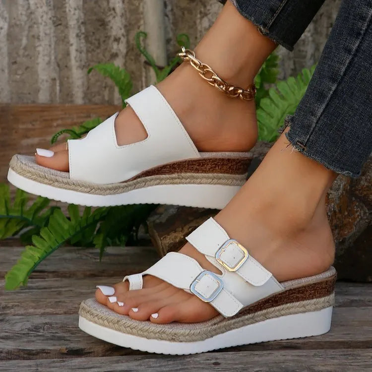White woven patent leather women's wedge sandals with a peep toe and finger-fit strap design.