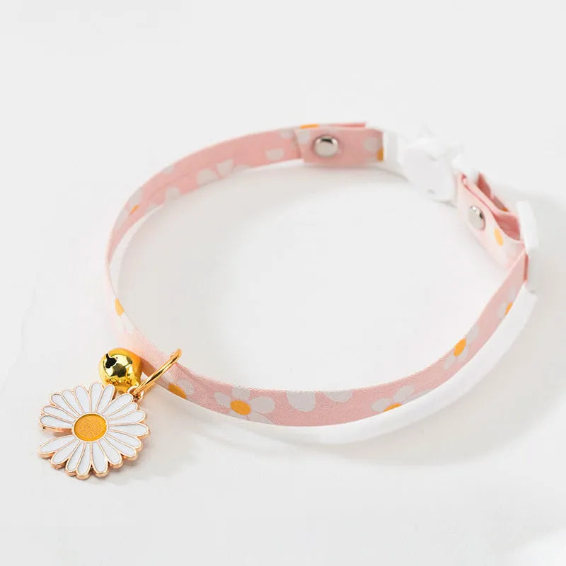 Green adjustable pet collar with a pink bow tie and silver bell for a small dog or cat