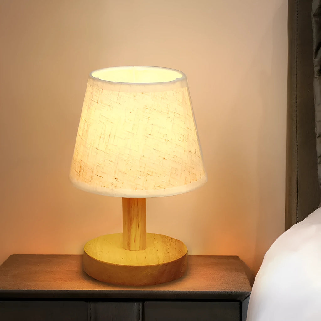 Korean style table lamp with white linen shade and bamboo holder on wooden table