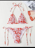 Women's pink floral halter neck bikini swimsuit with briefs on a mannequin.