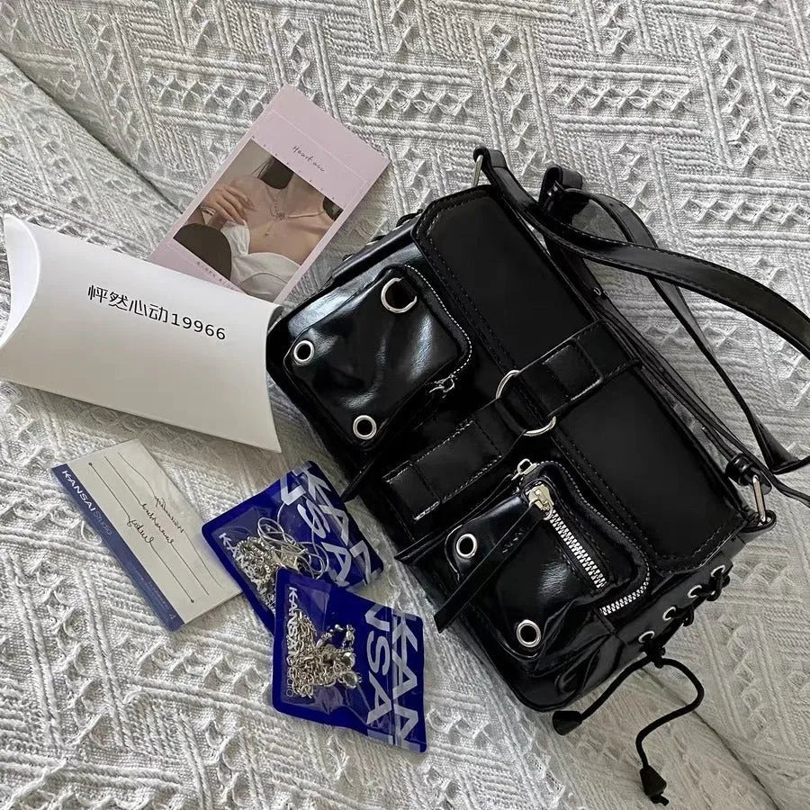 Black baguette-style women's messenger bag with a single crossbody strap