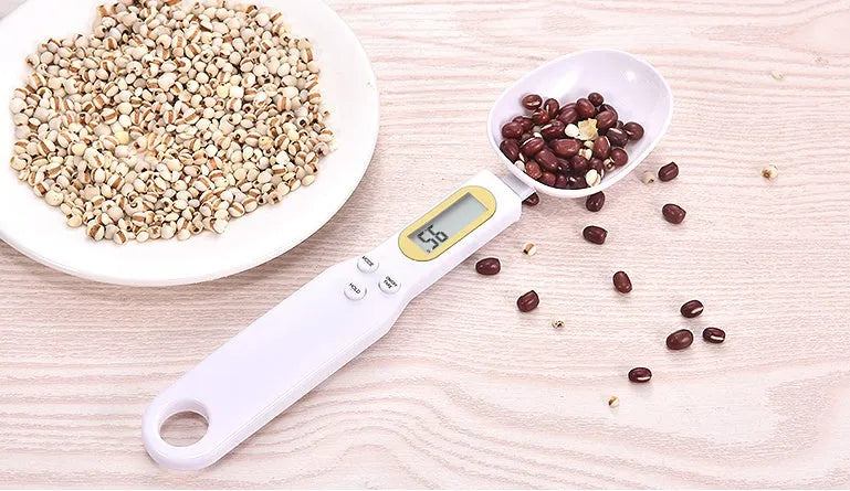 Black electronic measuring spoon scale showing digital display and spoon bowl for kitchen weighing