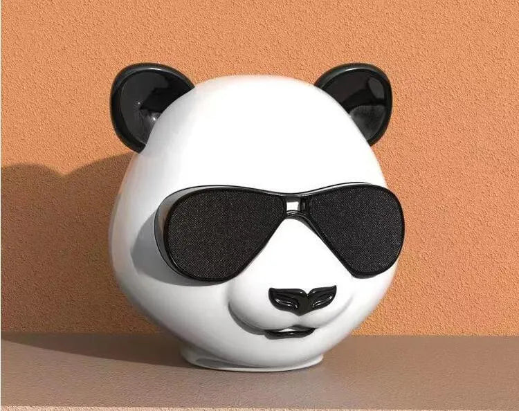 Portable mini Bluetooth speaker in classic style, showing front grill and likely a USB port.