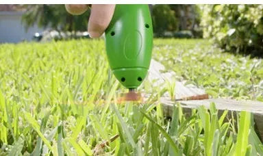 Cordless Zip Trim handheld lawn mower and weed trimmer with extension pole and debris shield.