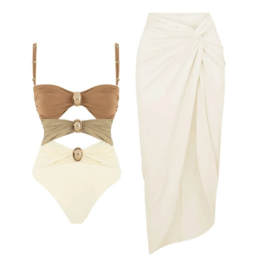 Women's solid colour one-piece swimsuit with gold buttons and a matching detachable skirt.