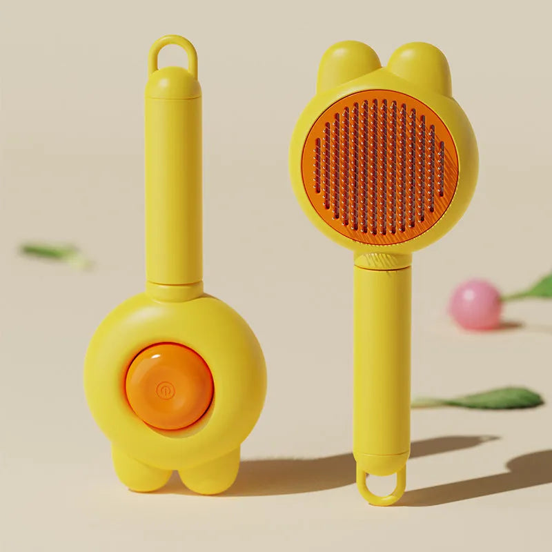 Self-cleaning pet brush with release button showing stainless steel comb teeth and coloured handle