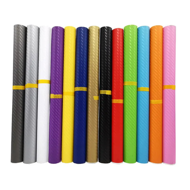 Roll of 3D carbon fibre car sticker showing black, silver, blue, and yellow colour options