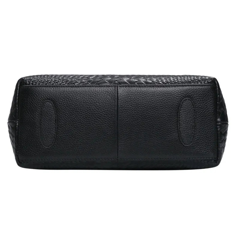 Black genuine leather woven crossbody bag with embossed finish, soft carry handle, and single shoulder strap.