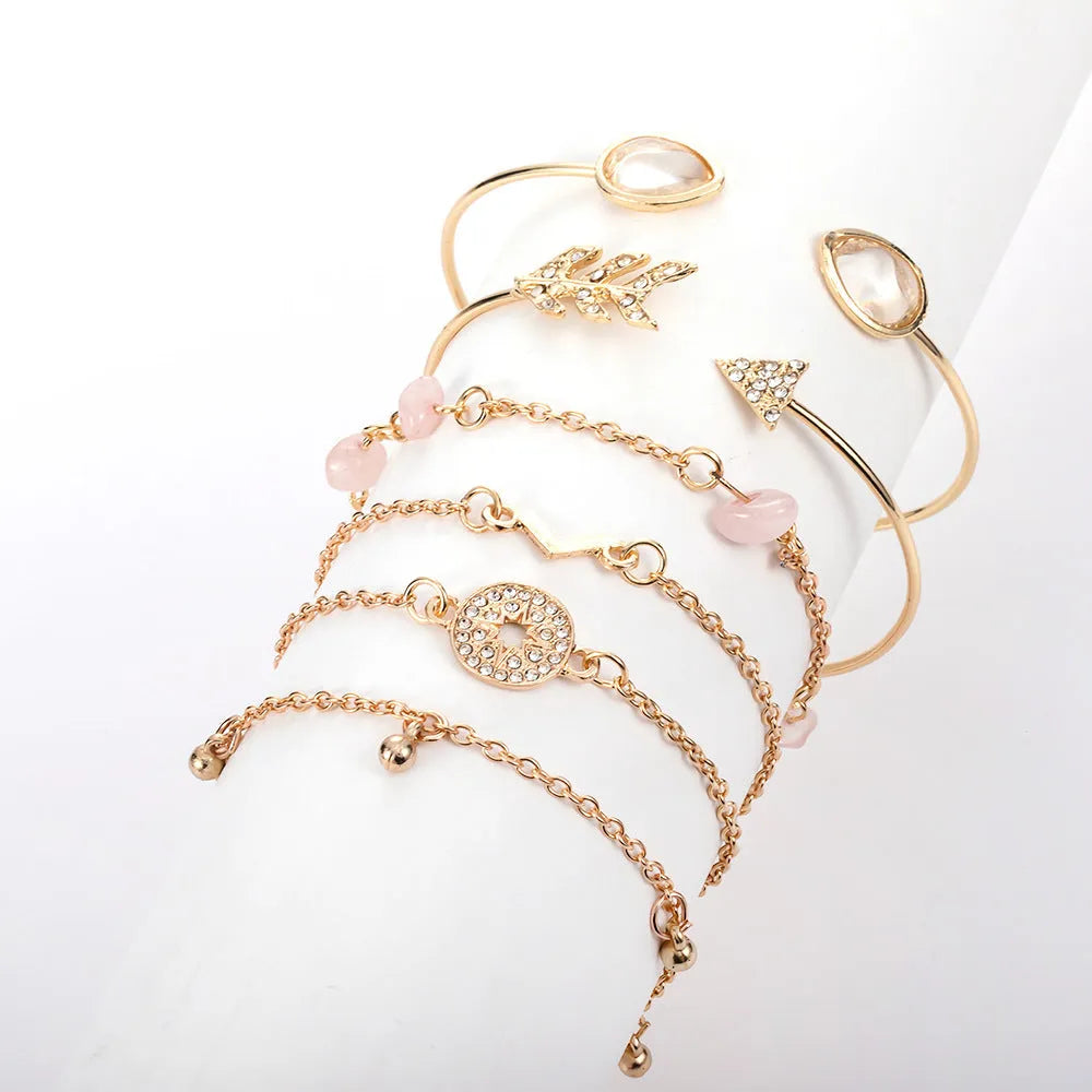Set of six gold-coloured women's bracelets with arrow, water drop, and V-shaped pendants.