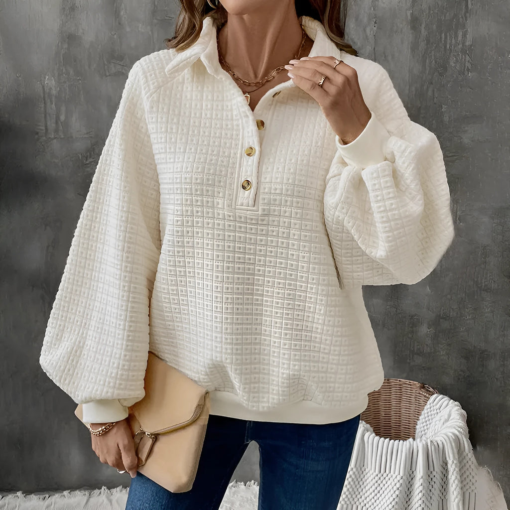 Women's beige polo collar pullover sweater with long sleeves, laid flat.