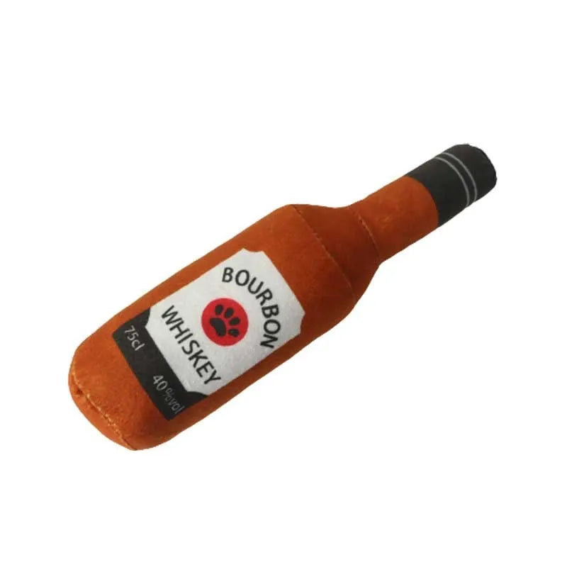 Green plush dog toy shaped like a wine bottle with a label, resting on a wooden floor.