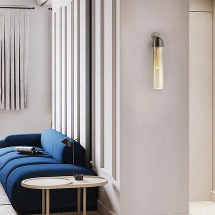Nordic minimalist glass wall lamp in smoke grey colour mounted on a light wall.