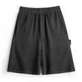 Cement grey men's straight-leg athletic shorts with elastic waistband on a plain background.
