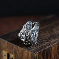 Silver open ring with a detailed domineering Jibeast animal pattern on a model's finger.