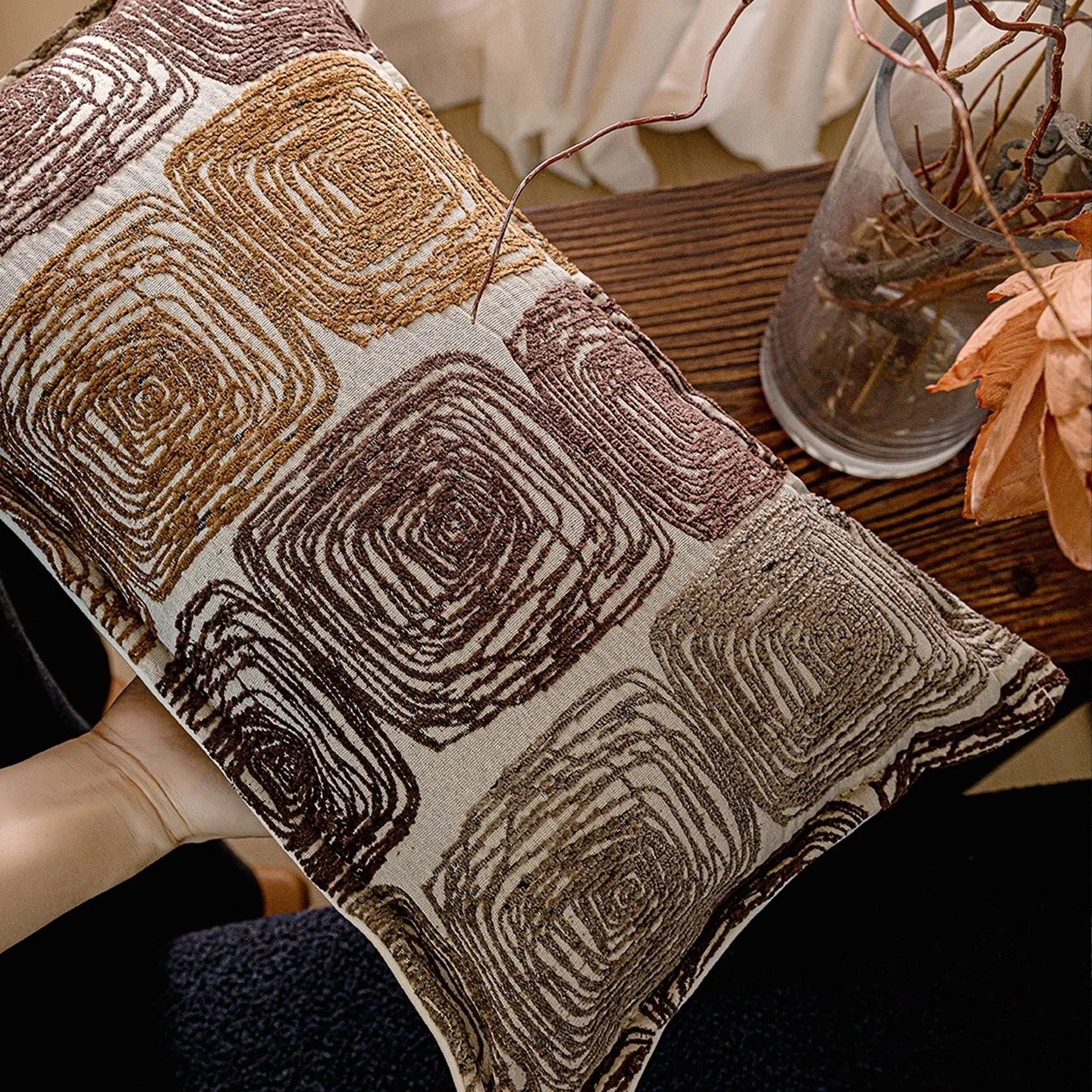 Cream and coffee abstract coil pattern square pillow cover made from polyester feather velvet.