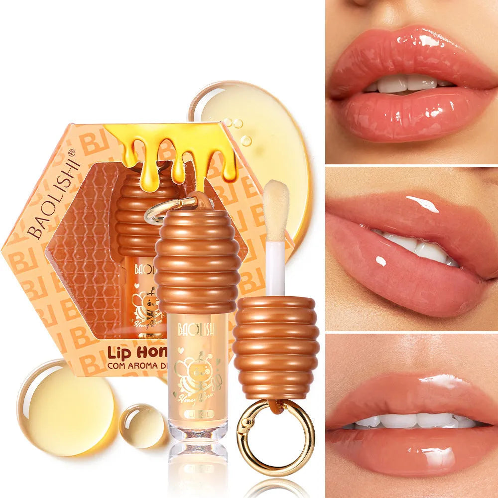 Portable honey lip gloss with keychain attached to bag strap