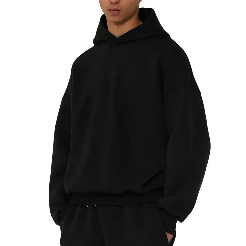 Man wearing a solid colour fleece-lined cotton pullover hoodie with a wool lining.