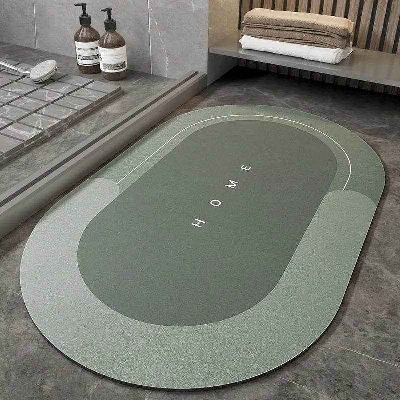 Blue oval blended fabric bathroom floor mat placed on tiled floor.