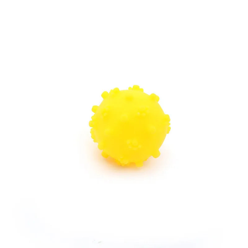 Set of four brightly coloured spiked squeaky dog balls on a blue background