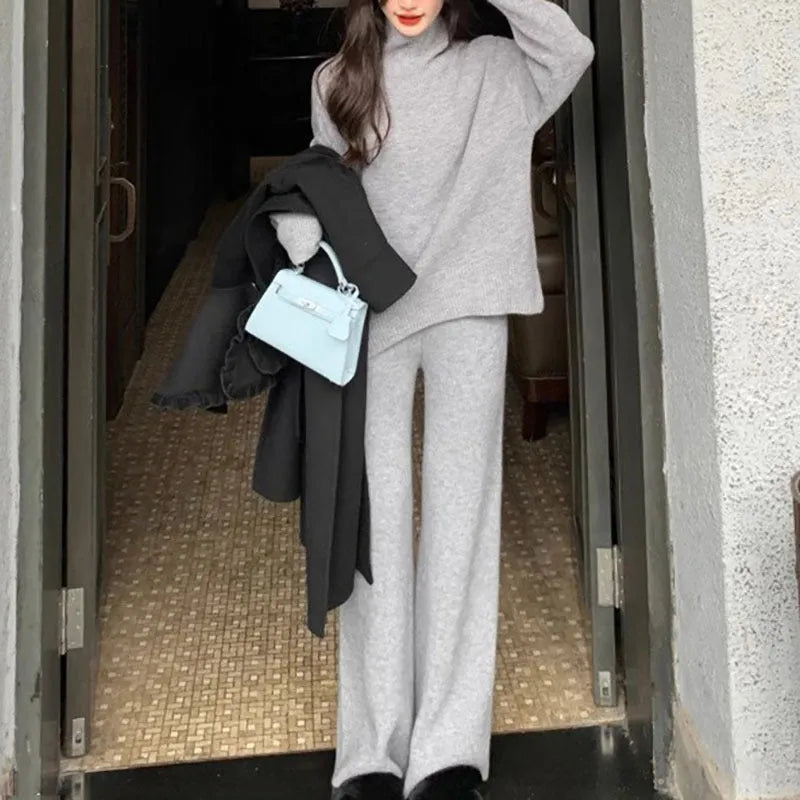Women's beige acrylic sweater and wide-leg trousers two-piece set on a hanger