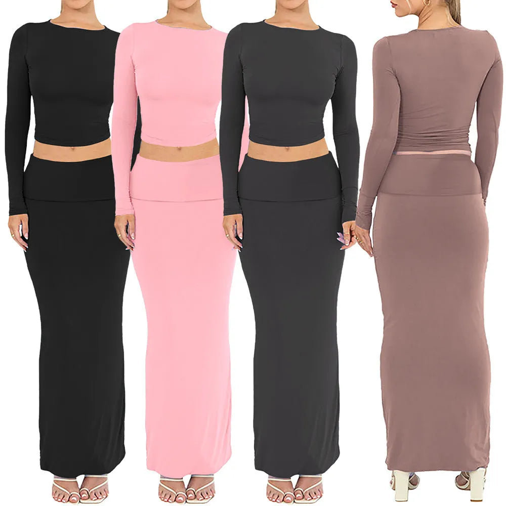 Women's black polyester two-piece suit with exposed navel top and long skirt.