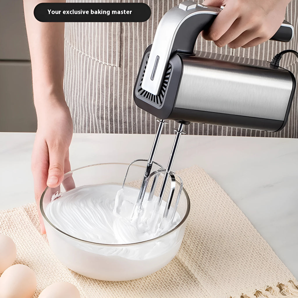 Silver handheld mini electric mixer with stainless steel beaters on a 5-speed dial.
