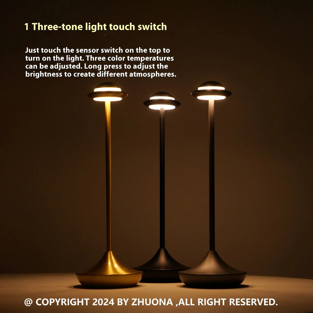 Metallic gold UFO-shaped table lamp with touch dimming on a wooden desk.