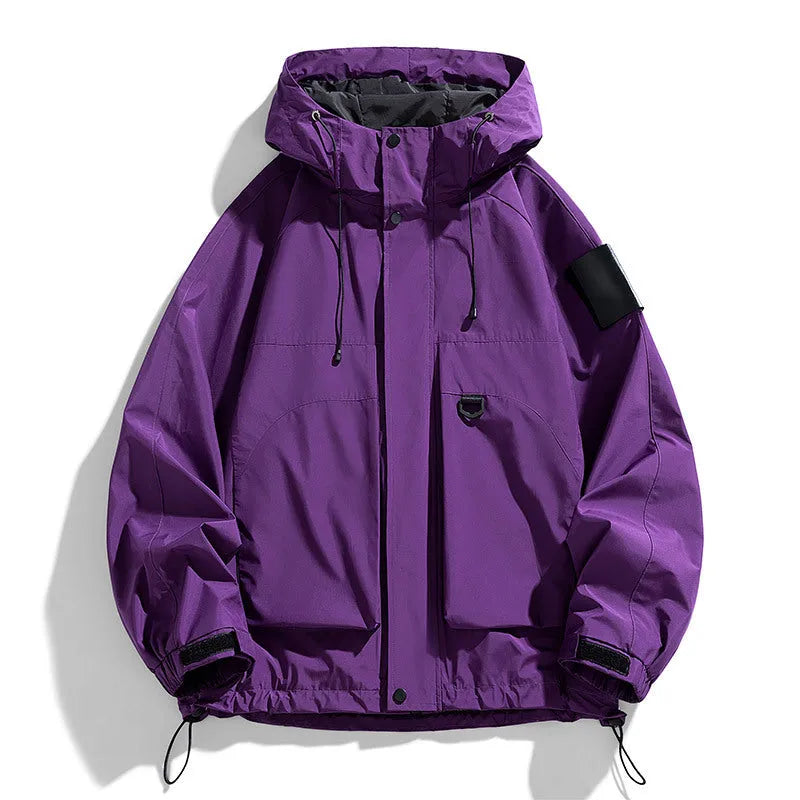 Man wearing a black waterproof windproof hooded jacket with long sleeves.