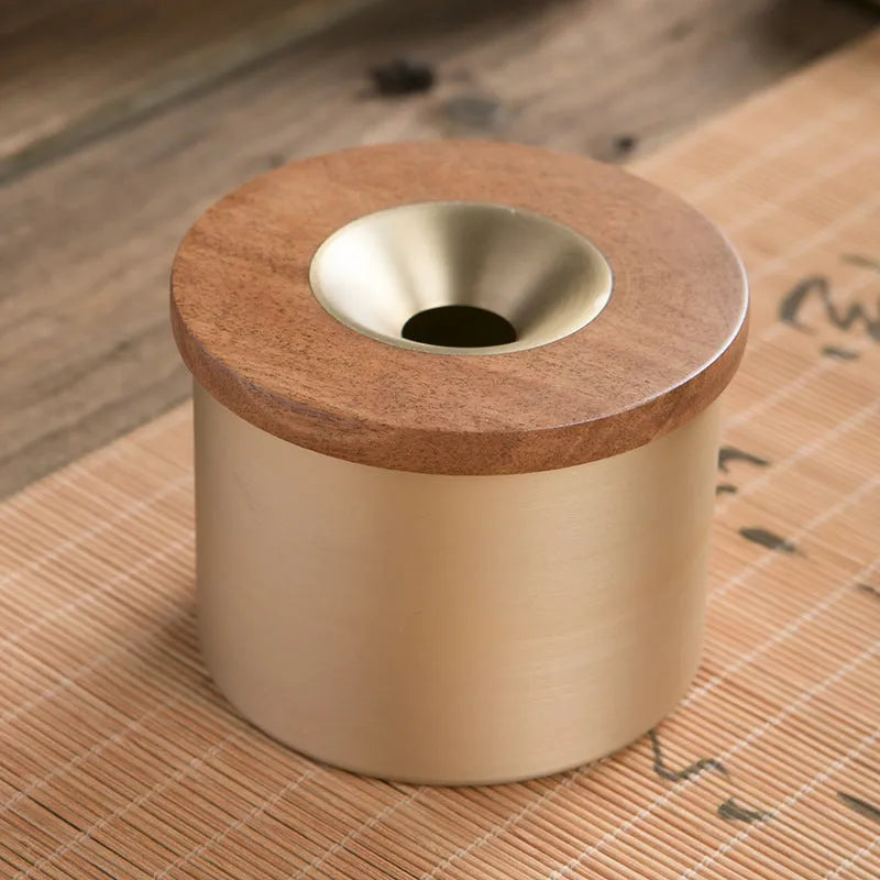 Brass ashtray with wooden lid featuring centre hole design