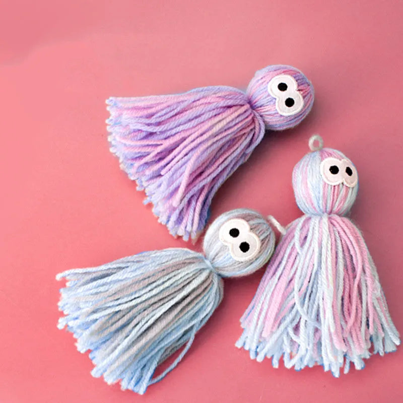 Set of four hanging wool ball cat toys with plastic teaser sticks in blue grey, pink and blue, and pink purple colours