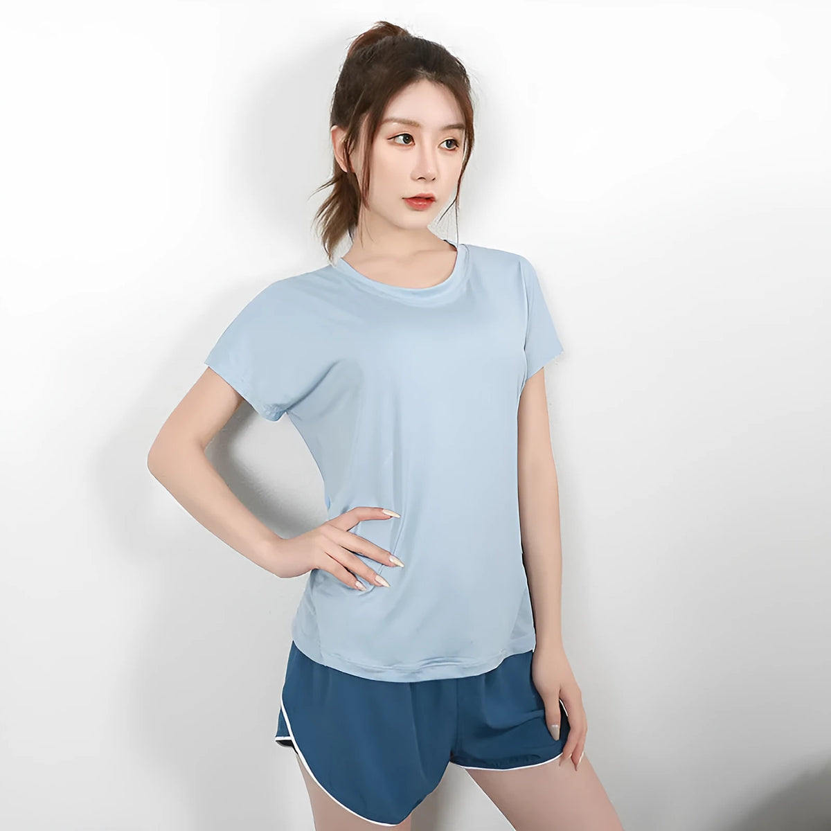 Women's short sleeve athletic t-shirt in sky blue, suitable for yoga and fitness.