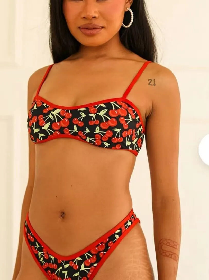 Women's cherry blossom print tube top bikini swimsuit set on a neutral background.