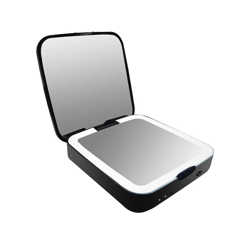 Black and white makeup mirror with dual magnification surfaces and adjustable lighting controls