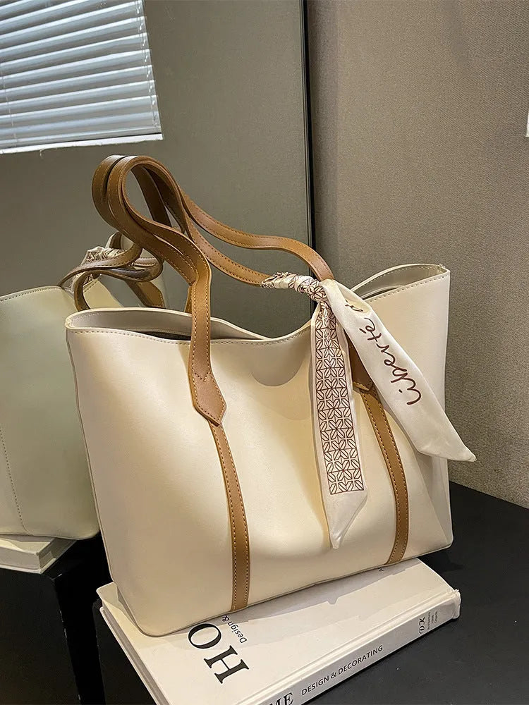 Large bucket-style tote bag with crossbody strap shown in multiple colour options