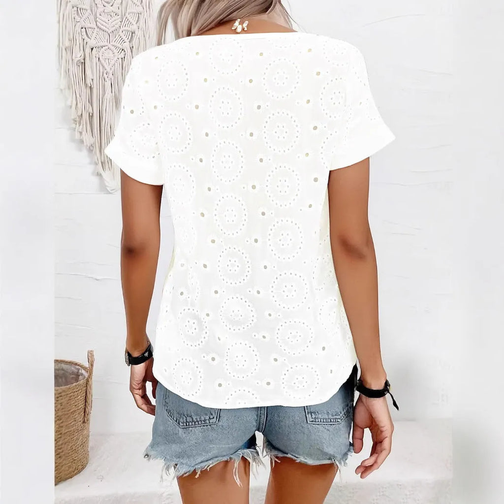 White women's V-neck T-shirt with hollow out pattern detail on the front.