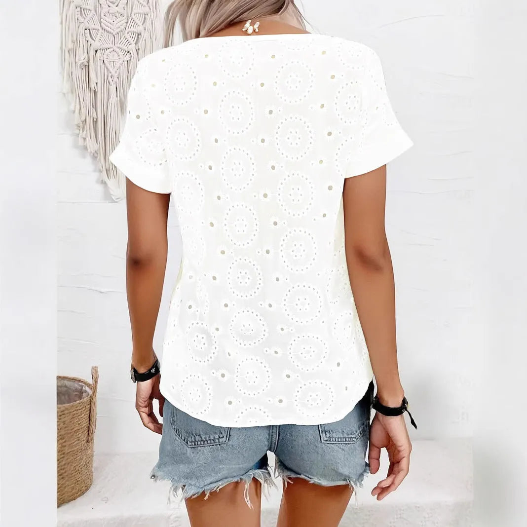 White women's V-neck T-shirt with hollow out pattern detail on the front.