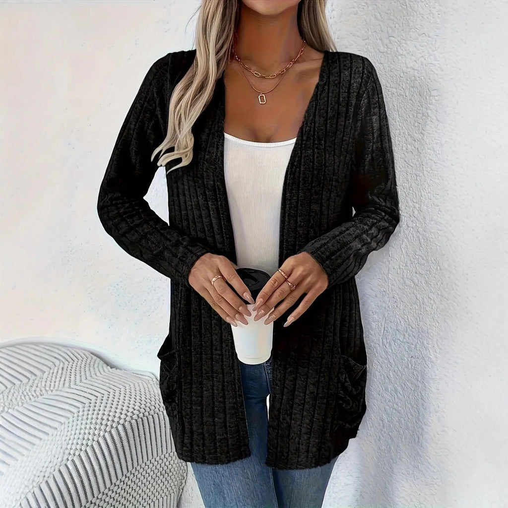 A solid colour long sleeve cardigan with pockets, shown in a loose fit on a model.
