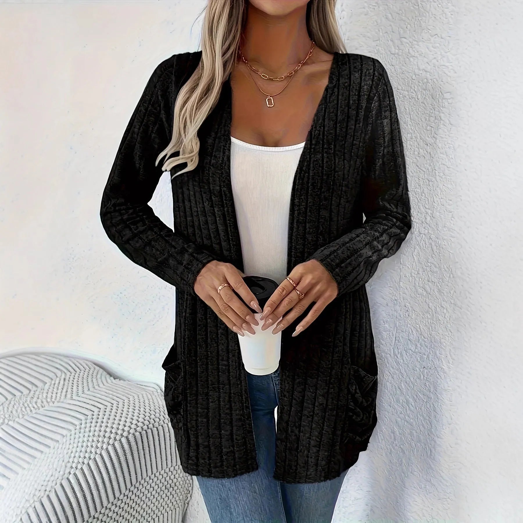 A solid colour long sleeve cardigan with pockets, shown in a loose fit on a model.