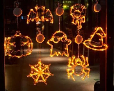 Halloween battery-powered LED window lights with suction cups showing spider, pumpkin and ghost designs