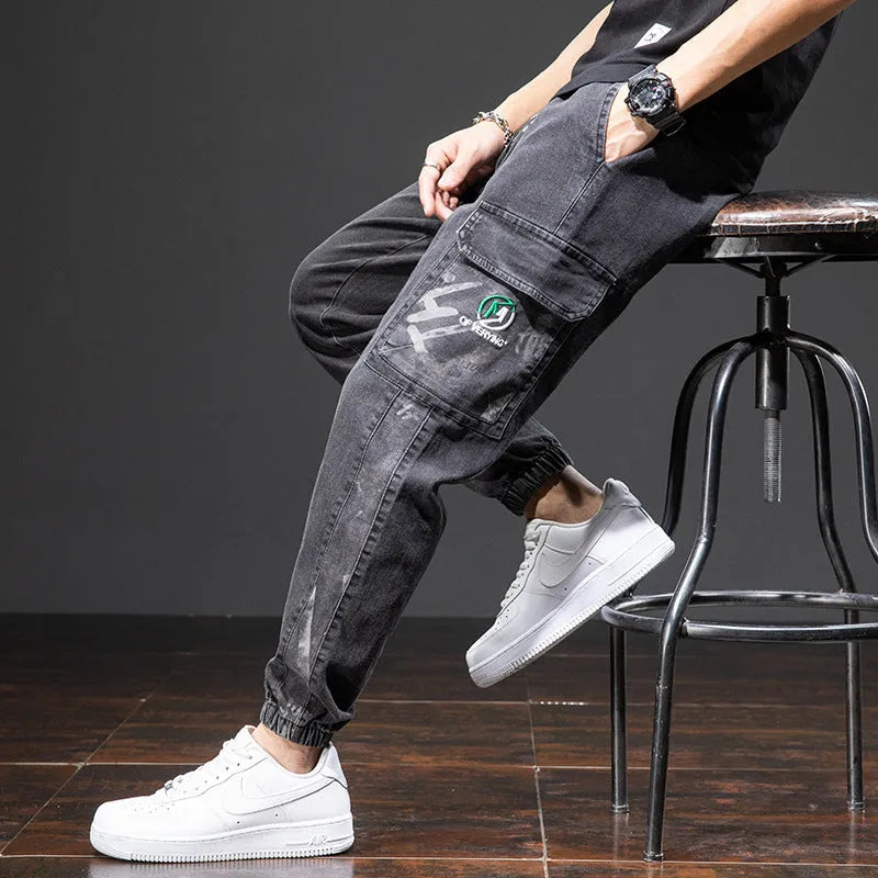 Men's loose-fit cargo jeans in blue, showing straight leg and mid-waist design on a hanger.