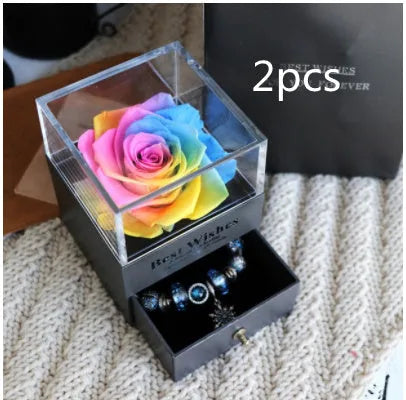 Glass eternal flower jewellery box with preserved roses and carnations inside measuring 8.5cm square