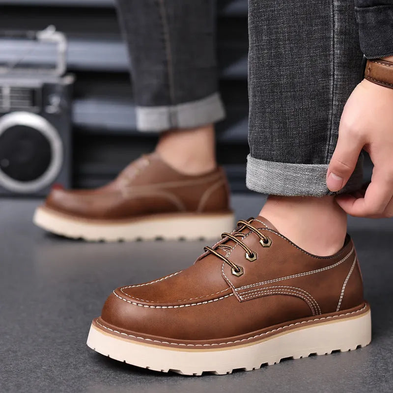 Men's black retro Martin boots with a round toe and rubber sole on a neutral background.
