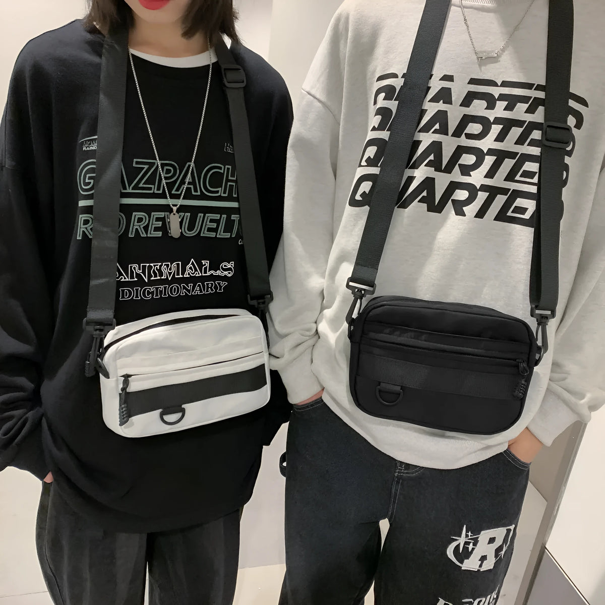 Men's street style nylon messenger crossbody bag in black showing 22cm length and sewing thread detailing