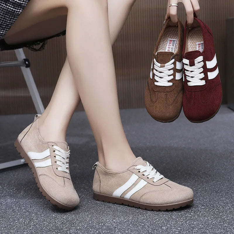 Women's vintage-style sneakers in dark red with a canvas upper and round toe.