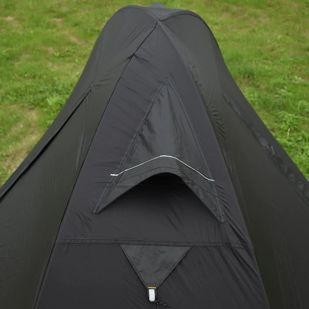 Single person orange hiking tent with aluminium poles pitched in outdoor setting