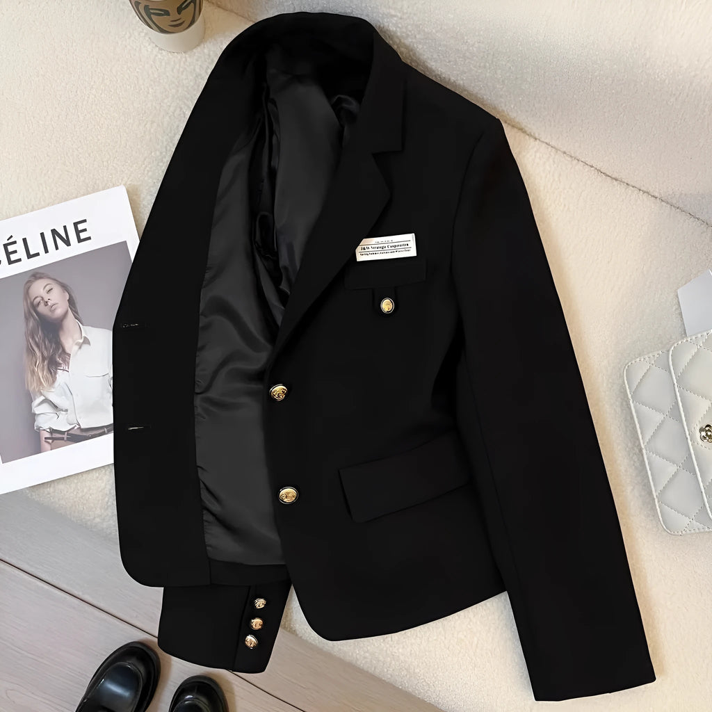 Black women's short suit coat with pockets, loose fit, and regular long sleeves.