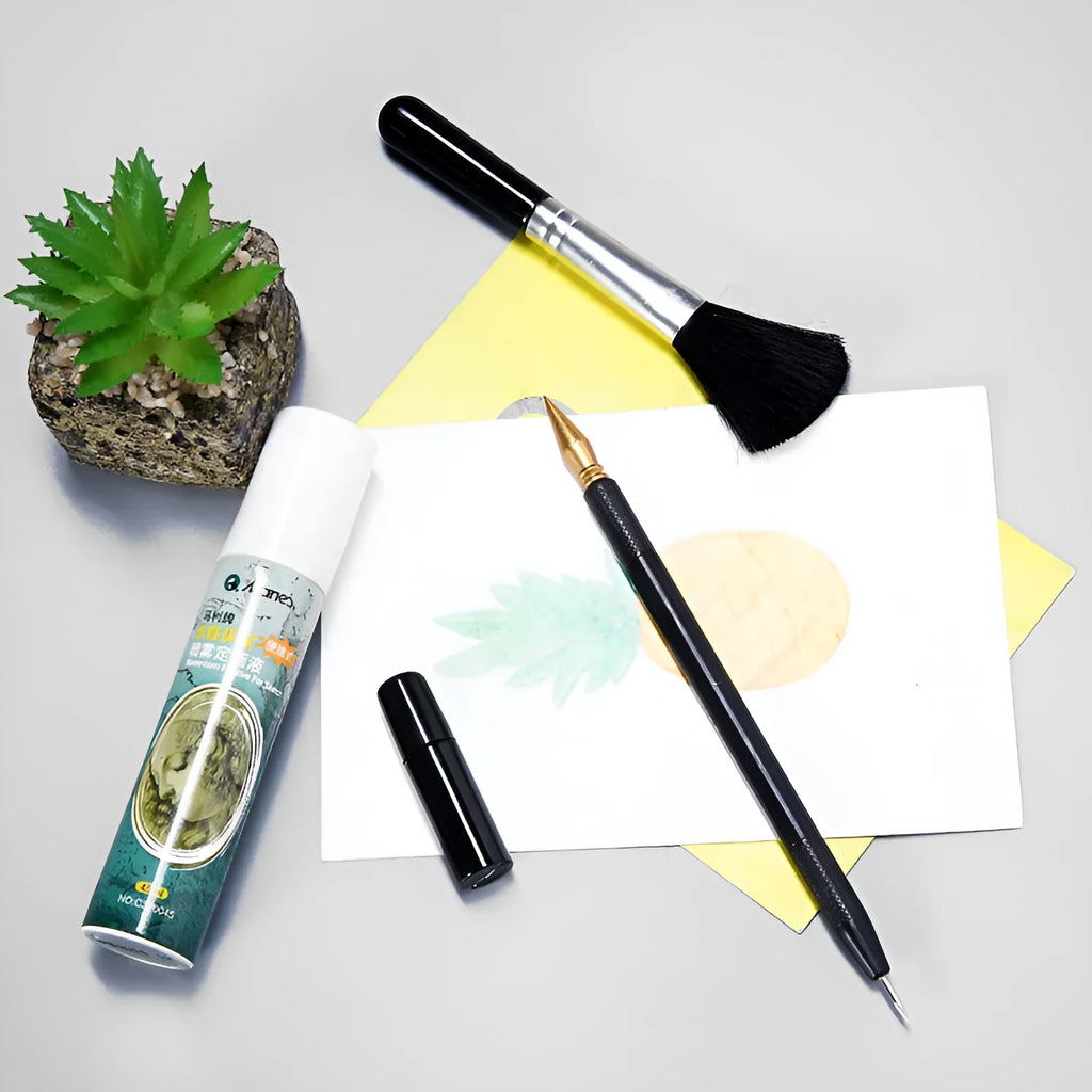 Scratch art pen tool kit with scraper, repair solution, brush, and bamboo stick on a craft table