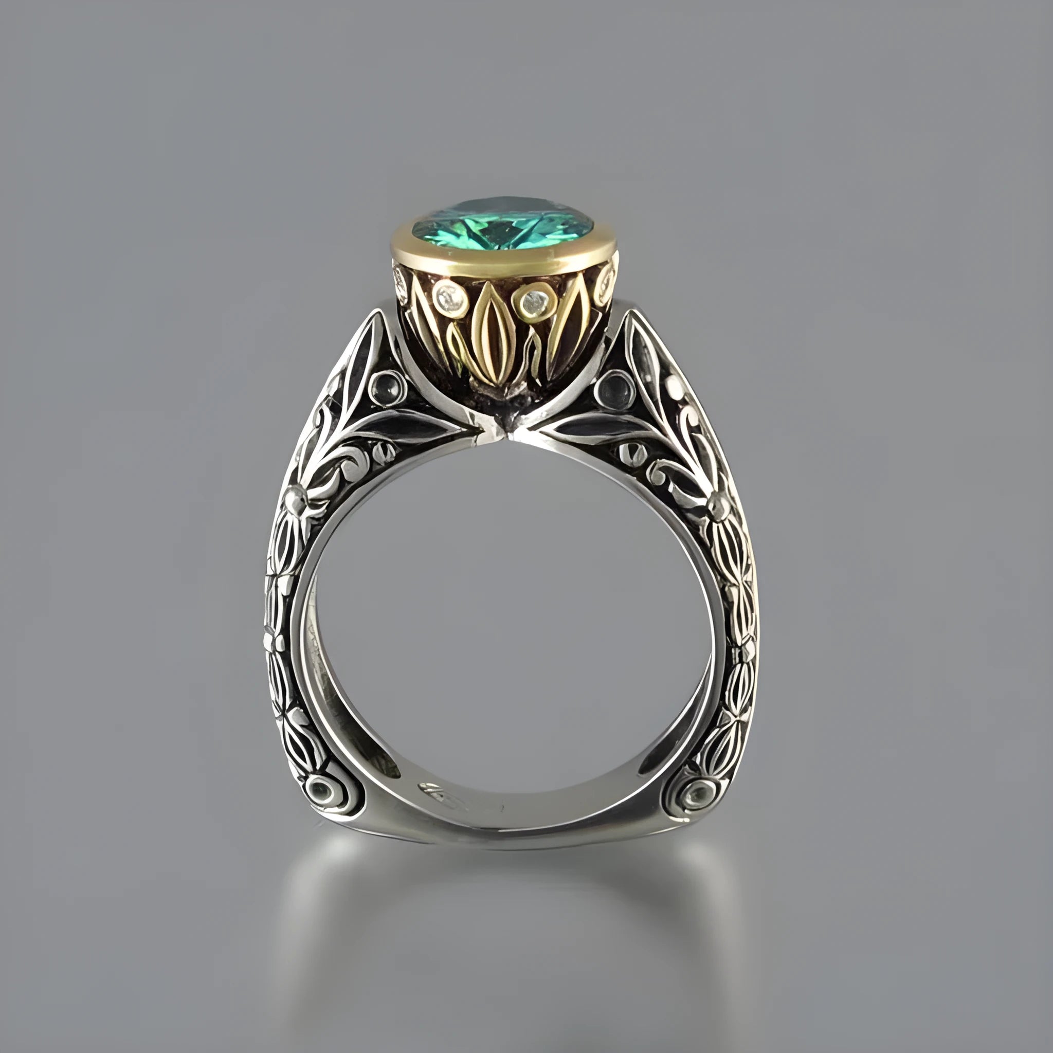 Flower-shaped vintage ring with gold-plated details and a green gemstone on a silver-toned alloy band.