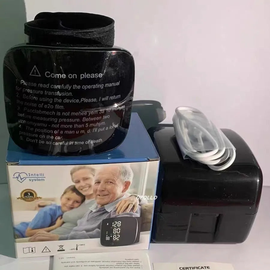 Black wrist blood pressure monitor with USB charging port and digital display.