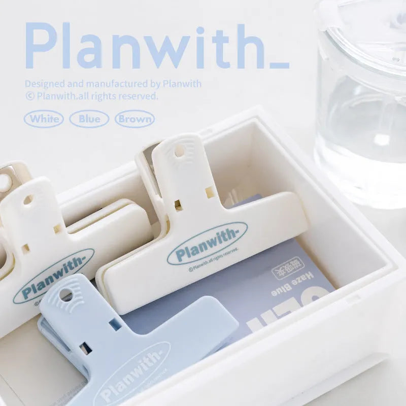 RosyPosy Haze Series blue magnetic bill clip holding receipts on a refrigerator.